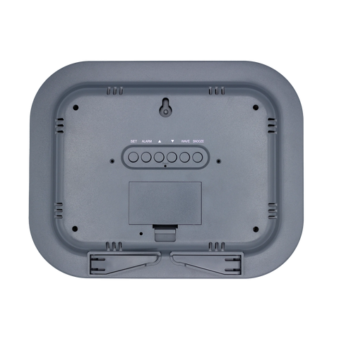 Back of digital clock showing battery compartment, kick stand and wall mount, and controls