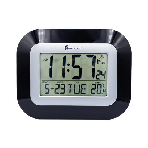 Digital clock that shows time, day, date and temperature. Black frame with silver screen bezel